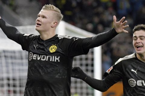 Dortmund's Erling Haaland celebrates after scoring his third goal of the game during the German Bundesliga soccer match between Borussia Dortmund FC Augsburg at the WWK Arena in Augsburg, Germany, Saturday, Jan. 18, 2020. (Tom Weller/dpa via AP)