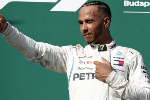 Mercedes driver Lewis Hamilton of Britain celebrates on the podium after winning the Hungarian Formula One Grand Prix, at the Hungaroring racetrack in Mogyorod, northeast of Budapest, Sunday, July 29, 2018. (AP Photo/Laszlo Balogh)