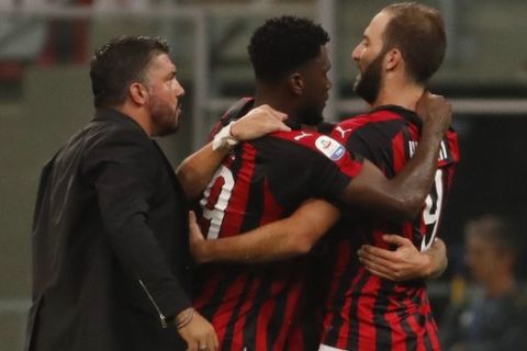 AC Milan coach Gennaro Gattuso, left, celebrates with Franck Kessie and Gonzalo Higuain, right, at the end of the Serie A soccer match between AC Milan and Roma at the Milan San Siro Stadium, Italy, Friday, Aug. 31, 2018. AC Milan won 2-1. (AP Photo/Antonio Calanni)