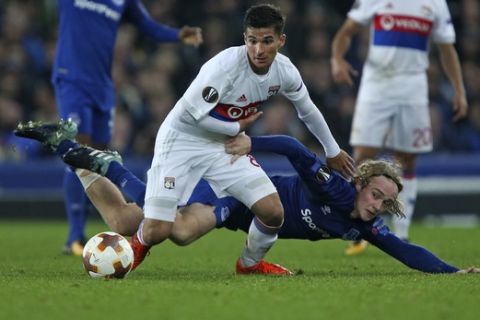 Everton's Tom Davies, down, and Lyon's Houssem Aouar challenge for the ball during a Group E Europa League soccer match between Everton F.C. and Olympique Lyon at Goodison Park Stadium, Liverpool, England, Thursday Oct. 19, 2017. (AP Photo/Dave Thompson)