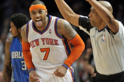New York Knicks forward Carmelo Anthony (7) reacts as referee Leon Wood signals he has hit a three-point shot against the Orlando Magic in the third quarter of their NBA basketball game at Madison Square Garden in New York, March 28, 2011. REUTERS/Ray Stubblebine  (UNITED STATES - Tags: SPORT BASKETBALL)