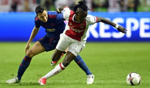 Ajax's Bertrand Traore, right, vies for the ball with United's Henrikh Mkhitaryan during the soccer Europa League final between Ajax Amsterdam and Manchester United at the Friends Arena in Stockholm, Sweden, Wednesday, May 24, 2017. (AP Photo/Martin Meissner)