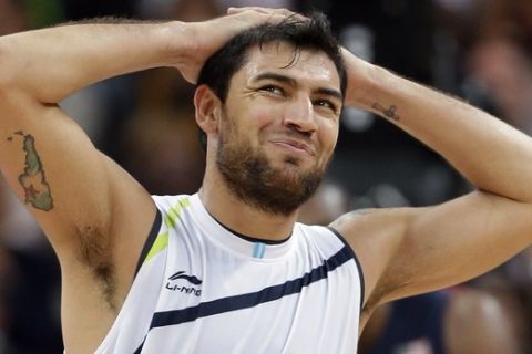 Argentina's Carlos Delfino, right, reacts after he was called for a foul against the USA during a preliminary men's basketball game at the 2012 Summer Olympics, Monday, Aug. 6, 2012, in London. (AP Photo/Eric Gay) ORG XMIT: OBKO208