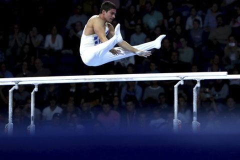 Nikolaos Iliopoulos of Greece performs on the parallel bars during men's qualifying sessions for the Gymnastics World Championships in Stuttgart, Germany, Sunday, Oct. 6, 2019. (AP Photo/Matthias Schrader)