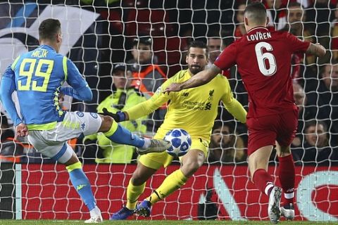 Napoli forward Arkadiusz Milik , left, shoots on goal during the Champions League Group C soccer match between Liverpool and Napoli at Anfield stadium in Liverpool, England, Tuesday, Dec. 11, 2018.(AP Photo/Dave Thompson)