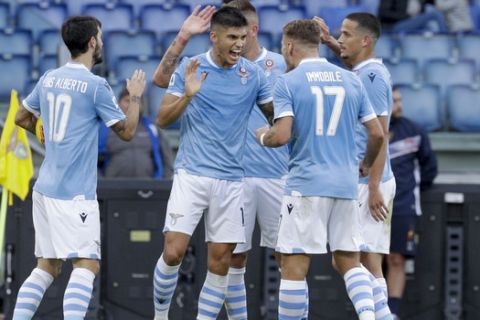 Lazio's Joaquin Correa, 2nd left, celebrates after scoring his side's opening goal during the Serie A soccer match between Lazio and Lecce at the Rome Olympic stadium, Sunday, Nov. 10, 2019. (AP Photo/Gregorio Borgia)