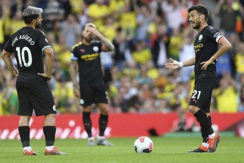 Manchester City's Sergio Aguero, left, and David Silva stand dejected after conceding the first goal during the English Premier League soccer match between Norwich City and Manchester City at Carrow Road, Norwich, England, Saturday, Sept. 14, 2019. (Joe Giddens/PA via AP)