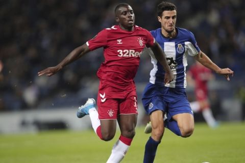 Rangers' Sheyi Ojo, left, challenges for the ball with Porto's Ivan Marcano during the Europa League group G soccer match between FC Porto and Rangers FC at the Dragao stadium in Porto, Portugal, Thursday, Oct. 24, 2019. (AP Photo/Luis Vieira)