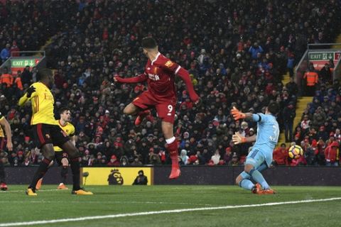 Liverpool's Roberto Firmino, center, scores his side's third goal during the English Premier League soccer match between Liverpool and Watford at Anfield, Liverpool, England, Saturday, March 17, 2018. (Anthony Devlin/PA via AP)