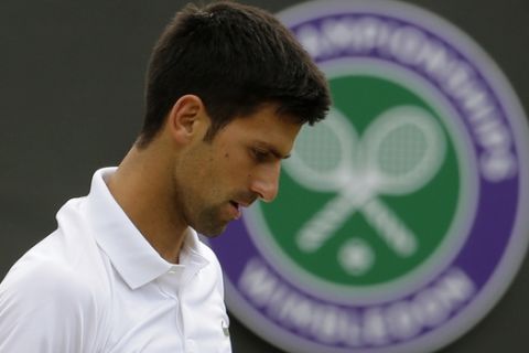 Serbia's Novak Djokovic pauses before serving to Czech Republic's Tomas Berdych during their Men's Singles Quarterfinal Match on day nine at the Wimbledon Tennis Championships in London Wednesday, July 12, 2017. (AP Photo/Alastair Grant)