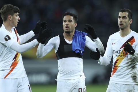 Roma's Justin Kluivert, center, celebrates with teammates Henrikh Mkhitaryan, right, and Gonzalo Villar at the end of the Europa League round 32 second leg soccer match between Gent and Roma at the KAA Gent stadium in Gent, Belgium, Thursday, Feb. 27, 2020. Roma won 2-1 on aggregate. (AP Photo/Francisco Seco)
