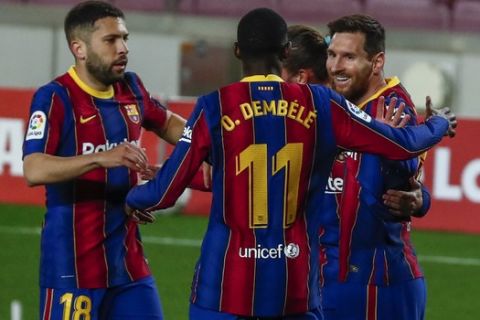 Barcelona's Lionel Messi, right, celebrates after scoring his side's first goal with teammates during the Spanish La Liga soccer match between FC Barcelona and Huesca at the Camp Nou stadium in Barcelona, Spain, Monday, March 15, 2021. (AP Photo/Joan Monfort)