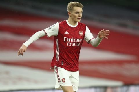 Arsenal's Martin Odegaard in action during the English Premier League soccer match between Arsenal and Leeds United at the Emirates stadium in London, England, Sunday, Feb. 14, 2021. (Julian Finney/Pool via AP)