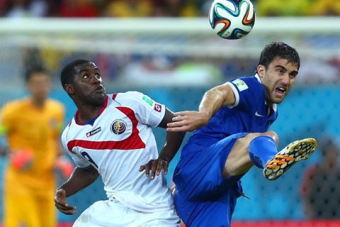 RECIFE, BRAZIL - JUNE 29: Joel Campbell of Costa Rica challenges Sokratis Papastathopoulos of Greece during the 2014 FIFA World Cup Brazil Round of 16 match between Costa Rica and Greece at Arena Pernambuco on June 29, 2014 in Recife, Brazil.  (Photo by Jeff Gross/Getty Images)