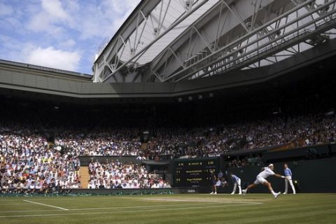 Switzerland's Roger Federer plays a return to Serbia's Novak Djokovic during the men's singles final match of the Wimbledon Tennis Championships in London, Sunday, July 14, 2019. (Laurence Griffiths/Pool Photo via AP)
