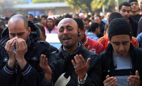 An Egyptian man cries as he joins others in prayer outside Al-Ahly club in Cairo on February 2, 2012. Egypt began three days of mourning after 74 people were killed in an eruption of violence at a football match between Al-Ahly and Al-Masry clubs that sparked new anger against the military rulers for failing to ensure security. AFP PHOTO/MAHMUD HAMS (Photo credit should read MAHMUD HAMS/AFP/Getty Images)