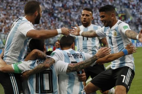 Argentina's Lionel Messi celebrates with his teammates after scoring the opening goal of his team during the group D match between Argentina and Nigeria, at the 2018 soccer World Cup in the St. Petersburg Stadium in St. Petersburg, Russia, Tuesday, June 26, 2018. (AP Photo/Petr David Josek)