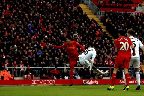 Liverpool's Roberto Firmino, center, scores his side's first goal of the game during the English Premier League soccer match between Liverpool and Swansea City at Anfield, Liverpool, England, Saturday, Jan. 21, 2017. (Peter Byrne/PA via AP)