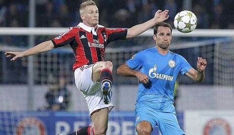 AC Milan's Ignazio Abate, left, fights for the ball with Zenit's Roman Shirokov  during the UEFA Champions League, group C, soccer match, between AC Milan  and Zenit St. Petersburg in St.Petersburg, Russia, Wednesday, Oct. 3, 2012. (AP Photo/Dmitry Lovetsky)