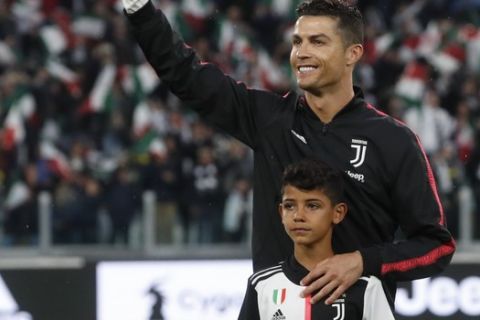 Juventus' Cristiano Ronaldo with his son Cristiano Jr prior to the Serie A soccer match between Juventus and Atalanta at the Allianz stadium, in Turin, Italy, Sunday, May 19, 2019. (AP Photo/Antonio Calanni)