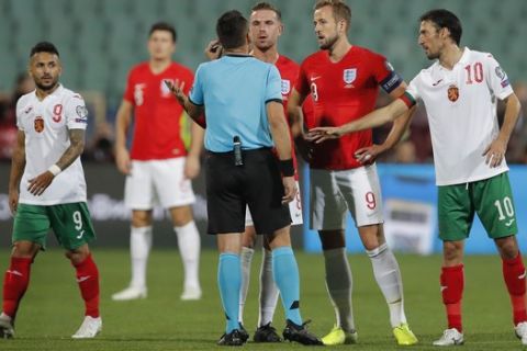 England's Harry Kane, second right, and England's Jordan Henderson, center, speak with Referee Ivan Bebek during during the Euro 2020 group A qualifying soccer match between Bulgaria and England, at the Vasil Levski national stadium, in Sofia, Bulgaria, Monday, Oct. 14, 2019. (AP Photo/Vadim Ghirda)