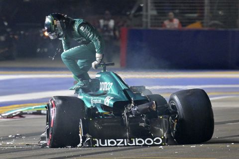 Aston Martin driver Lance Stroll of Canada goes out from his car after a crash during the qualifying session of the Singapore Formula One Grand Prix at the Marina Bay circuit, Singapore, Saturday, Sept. 16, 2023. (Caroline Chia/Pool Photo via AP)