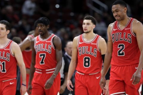 Chicago Bulls' Jabari Parker (2), Zach LaVine (8), Justin Holiday (7) and Ryan Arcidiacono (51) react as they walk on the court during the second half of an NBA basketball game against the Dallas Mavericks, Monday, Nov. 12, 2018, in Chicago. The Mavericks won 103-98. (AP Photo/Nam Y. Huh)