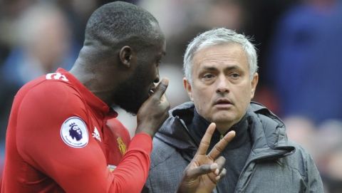 Manchester United manager Jose Mourinho listens to Manchester United's Romelu Lukaku during the English Premier League soccer match between Manchester United and Liverpool at Old Trafford in Manchester, England, Saturday, March 10, 2018. (AP Photo/Rui Vieira)