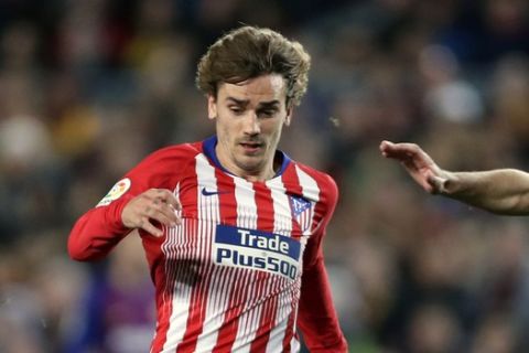 FILE - In this April 6, 2019, file photo, Atletico forward Antoine Griezmann, center, vies for the ball with Barcelona midfielder Arthur, left, and Barcelona defender Clement Lenglet, right, during a Spanish La Liga soccer match in Barcelona, Spain. Atletico Madrid will be the opponent for the Major League Soccer All-Star game this summer in Orlando. The 10-time La Liga champions are the second team from the league to play the domestic All-Stars, joining Real Madrid, the opponents in the 2017 game in Chicago. (AP Photo/Manu Fernandez, File)