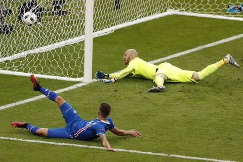 Iceland's Arnor Ingvi Traustason, bottom, scores his side's second goal past Austria goalkeeper Robert Almer, top, during the Euro 2016 Group F soccer match between Iceland and Austria at the Stade de France in Saint-Denis, north of Paris, France, Wednesday, June 22, 2016. (AP Photo/Francois Mori)