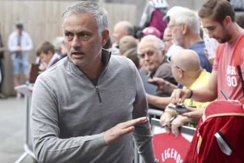 Manchester United manager Jose Mourinho signs autographs for fans before a Premier League soccer match between Burnley and Manchester City, at Turf Moor, Burnley, Britain, Sunday, Sept. 2, 2018. (Martin Ricket/PA via AP)