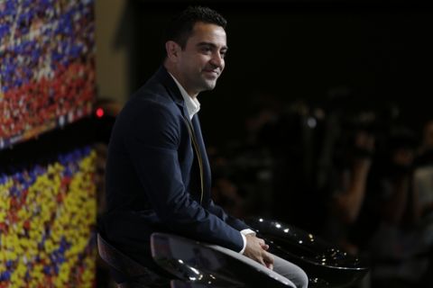 FC Barcelona Xavi Hernandez attends a conference for his farewell event at the Camp Nou stadium in Barcelona, Spain, Wednesday, June 3, 2015. FC Barcelona midfielder Xavi Hernandez says he will leave the Catalan club after 17 trophy-laden seasons in which he set club records for appearances and titles won. The 35-year-old Xavi says he will cut his contract short by one year and leave after this season to go play for Qatari club Al-Sadd on a two-year contract. (AP Photo/Manu Fernandez)