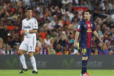 FC Barcelona's Lionel Messi from Argentina, right, and Real Madrid's Cristiano Ronaldo from Portugal gesture during their Spanish Supercup first leg soccer match at the Camp Nou stadium in Barcelona, Spain, Thursday, Aug. 23, 2012. (AP Photo/Andres Kudacki)