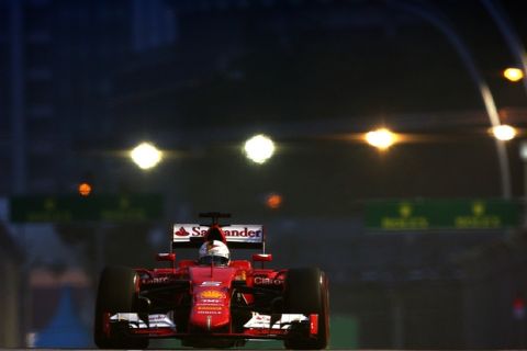SINGAPORE - SEPTEMBER 19:  Sebastian Vettel of Germany and Ferrari drives during final practice for the Formula One Grand Prix of Singapore at Marina Bay Street Circuit on September 19, 2015 in Singapore.  (Photo by Clive Mason/Getty Images)