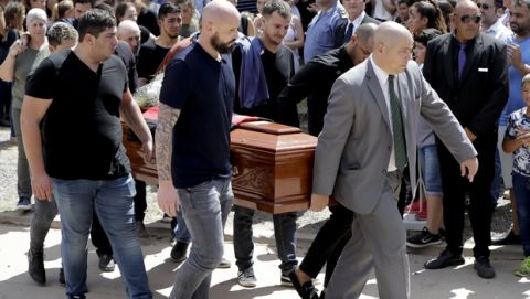Nantes defender Nicolas Pallois, second riht, and family and friends of Argentina soccer player Emiliano Sala carry Sala's coffin during his funeral in Progreso, Argentina, Saturday, Feb. 16, 2019. The Argentina-born forward died in an airplane crash in the English Channel last month when flying from Nantes in France to start his new career with English Premier League club Cardiff. (AP Photo/Natacha Pisarenko)