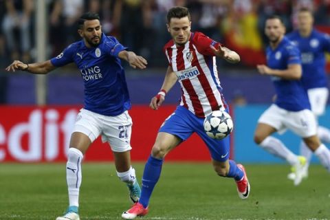 Leicester's Riyad Mahrez, left, vies for the ball with Atletico's Saul Niguez during the Champions League quarterfinal first leg soccer match between Atletico Madrid and Leicester City at the Vicente Calderon stadium in Madrid, Wednesday, April 12, 2017. (AP Photo/Francisco Seco)