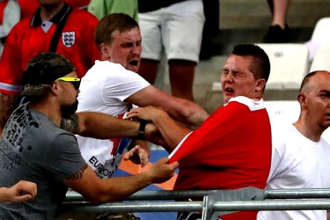 Russian supporters attack an England fan at the end of the Euro 2016 Group B soccer match between England and Russia, at the Velodrome stadium in Marseille, France, Saturday, June 11, 2016.  (AP Photo/Thanassis Stavrakis)