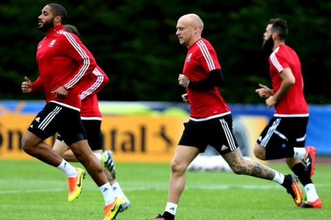 Wales' Ashley Williams, left, and David Cotterill run on the pitch during a training session in Dinard, western France, Tuesday, July 5, 2016. Wales will face Portugal in a Euro 2016 semifinal match at the Grand Stade in Decines-Charpieu, near Lyon, France, Wednesday, July 6, 2016. (AP Photo/David Vincent)