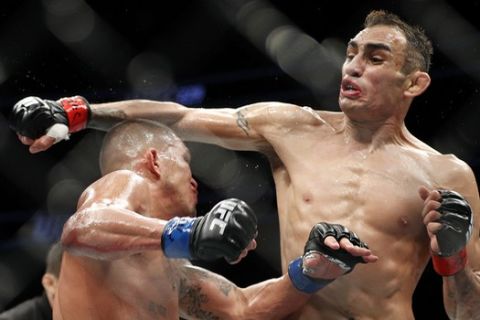 Tony Ferguson, right, fights Anthony Pettis during a lightweight mixed martial arts bout mixed martial arts bout at UFC 229 in Las Vegas, Saturday, Oct. 6, 2018. Ferguson won by technical knockout during the second round. (AP Photo/John Locher)