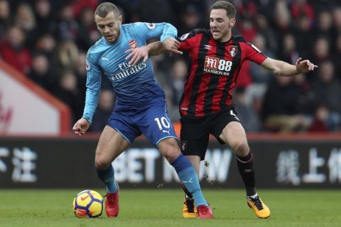 Arsenal's Jack Wilshere, left, holds off Bournemouth's Dsan Gosling during the English Premier League soccer match at the Vitality Stadium in Bournemouth, England, Sunday Jan. 14, 2018. (David Davies/PA via AP)