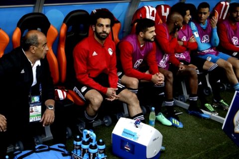 Egypt's Mohamed Salah, second left, sits on the bench ahead the group A match between Egypt and Uruguay at the 2018 soccer World Cup in the Yekaterinburg Arena in Yekaterinburg, Russia, Friday, June 15, 2018. (AP Photo/Mark Baker)
