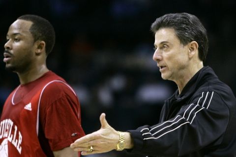 Louisville head coach Rick Pitino directs his team as guard Jerry Smith, left, looks on during basketball practice at the NCAA East Regional, Wednesday, March 26, 2008, in Charlotte. Louisville plays Tennessee on Thursday. (AP Photo/Chuck Burton) 