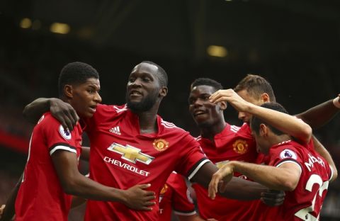 Manchester United's Romelu Lukaku, second left, celebrates scoring his side's first goal of the game during the English Premier League soccer match between Manchester United and West Ham United at Old Trafford in Manchester, England, Sunday, Aug. 13, 2017. (AP Photo/Dave Thompson)