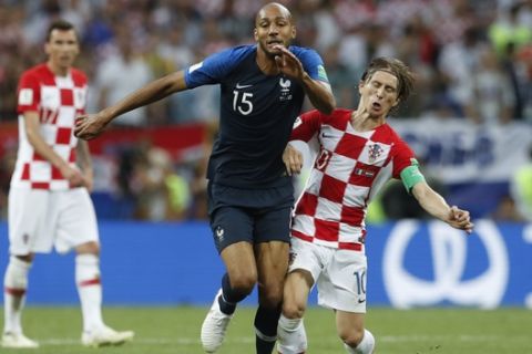 France's Steven Nzonzi is challenged by Croatia's Luka Modric, right, during the final match between France and Croatia at the 2018 soccer World Cup in the Luzhniki Stadium in Moscow, Russia, Sunday, July 15, 2018. (AP Photo/Petr David Josek)