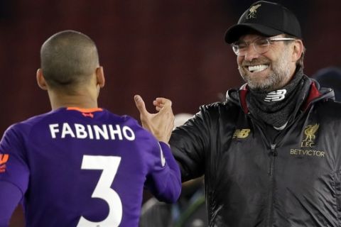 Liverpool's manager Juergen Klopp, right, celebrates with Liverpool's Fabinho at the end of the English Premier League soccer match between Southampton and Liverpool at St Mary's stadium in Southampton, England Friday, April 5, 2019. (AP Photo/Kirsty Wigglesworth)