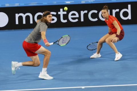 Stefanos Tsitsipas and Maria Sakkari of Greece during their mixed doubles match against Switzerland's Roger Federer and Belinda Bencic at the Hopman Cup in Perth, Australia, Thursday Jan. 3, 2019. (AP Photo/Trevor Collens)