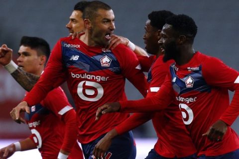 Lille's Burak Yilmaz, center, reacts with teammates after scoring during their French League One soccer match between Lille and Nice in Villeneuve d'Ascq, northern France, Saturday May. 1, 2021. (AP Photo/Michel Spingler)