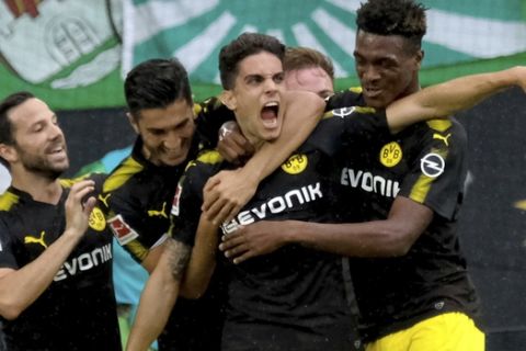 Dortmund's Marc Bartra, third left, celebrates his goal together with Gonzalo Castro. left,  Nuri Sahin, second left,  and Dan-Axel Zagadou, right,  during the German Bundesliga soccer match between VfL Wolfsburg and Borussia Dortmund in  Wolfsburg, Germany, Saturday, Aug. 19,  2017. (Peter Steffen/dpa via AP)