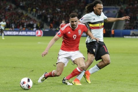 Wales' Hal Robson Kanu, left, challenges for the ball with Belgium's Jason Denayer during the Euro 2016 quarterfinal soccer match between Wales and Belgium, at the Pierre Mauroy stadium in Villeneuve dAscq, near Lille, France, Friday, July 1, 2016. (AP Photo/Petr David Josek)
