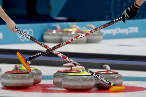 Canada's Kaitlyn Lawes, left, and John Morris hold their brooms during a mixed double curling match against Norway's Kristin Skaslien and Magnus Nedregotten at the 2018 Winter Olympics in Gangneung, South Korea, Thursday, Feb. 8, 2018. (AP Photo/Natacha Pisarenko)